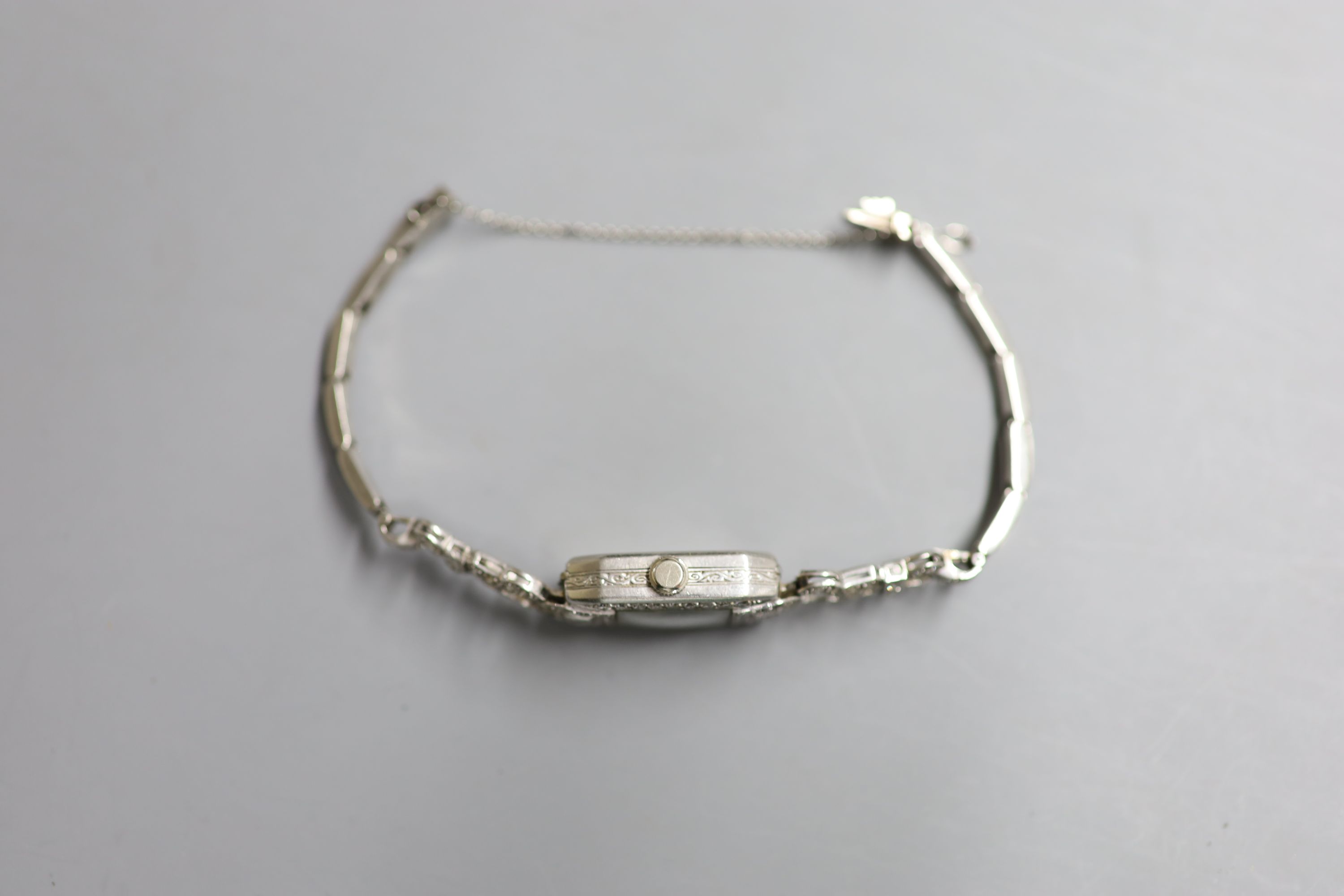 A ladys 1940s white metal (stamped platinum) and diamond set cocktail watch,